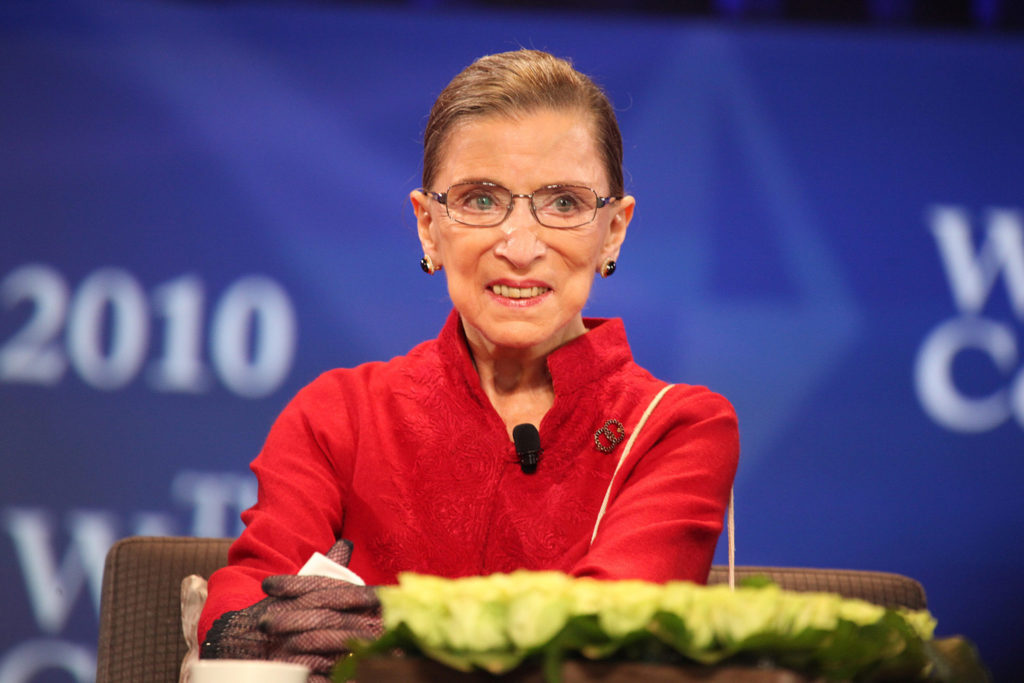 Ruth Bader Ginsburg seated at a table